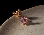 Flower-inspired amethyst gemstone studs in gold — pair view