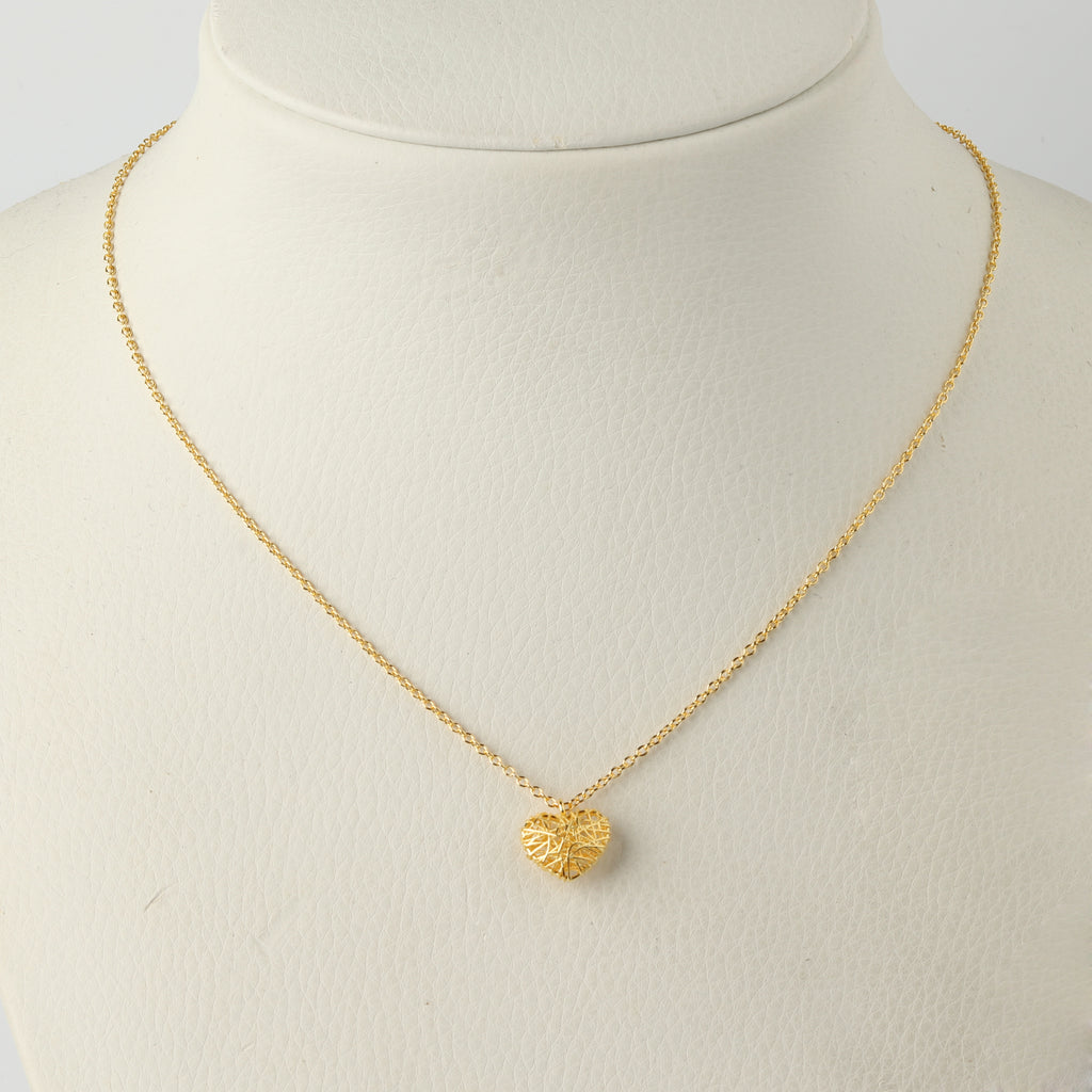 Close-up of gold finish heart necklace in 925 sterling silver with filigree detailing by Jewelry by Crimson