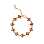 Gold flower bracelet with red gemstone petals and colorful center stones, elegant women's jewelry