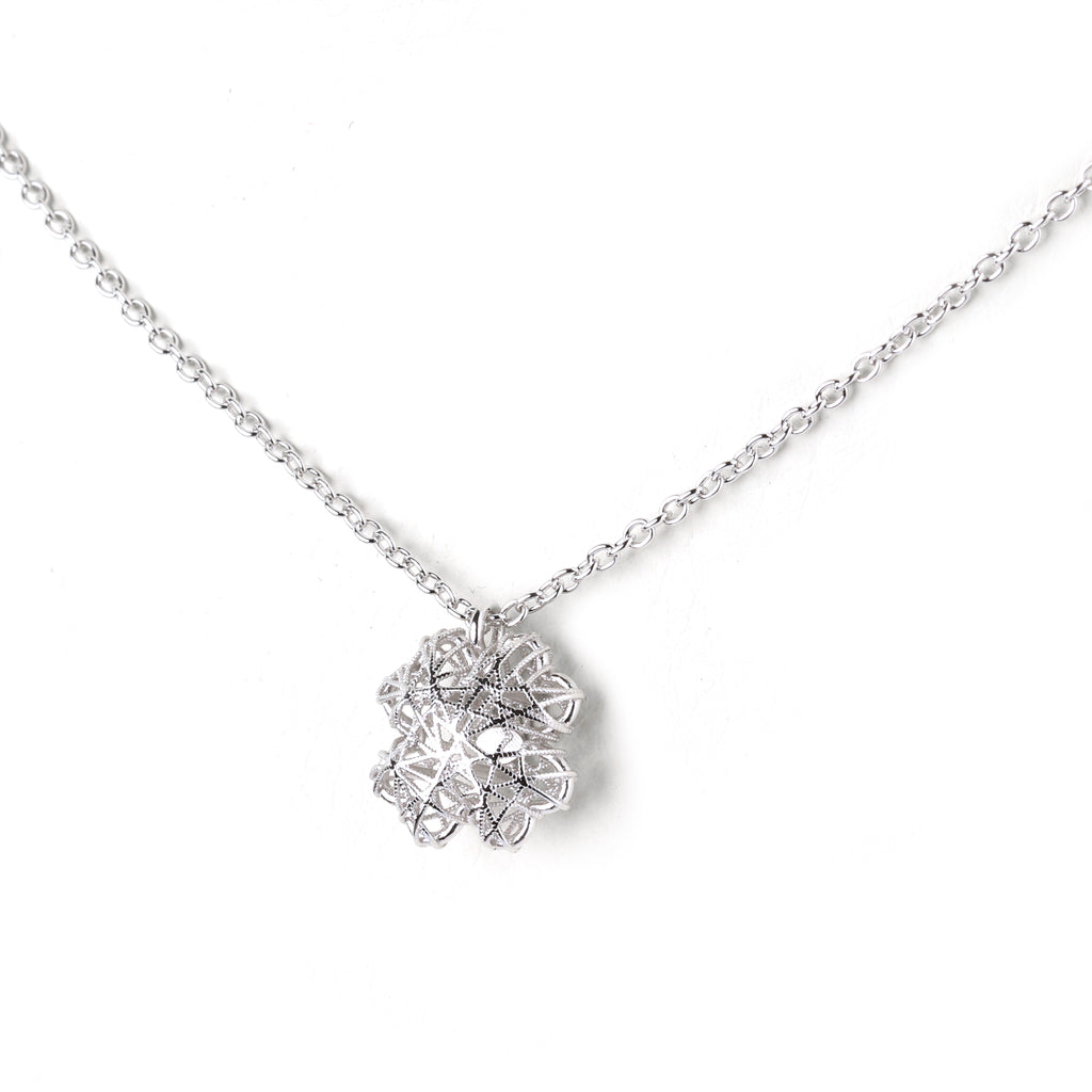 Detailed view of floral mandala silver pendant with high-polish finish