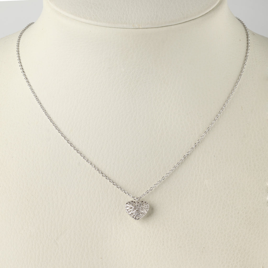Close-up of 925 sterling silver heart necklace with leaf engraved texture, high-polish finish by Jewelry by Crimson