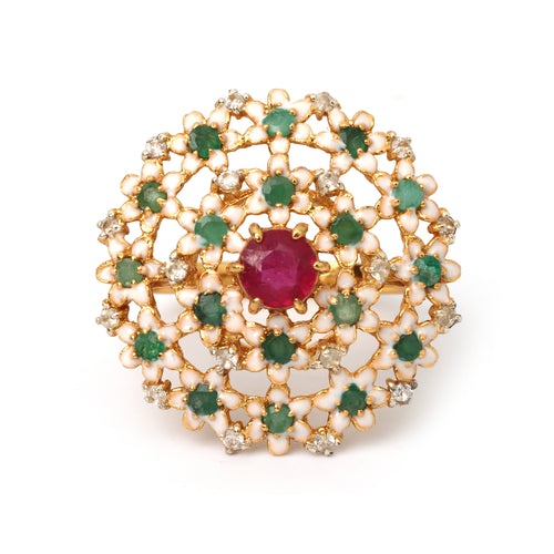 Gold ring with central ruby, emerald accents, and diamond details in floral enamel design