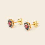 Gold earrings with gemstones on a white background