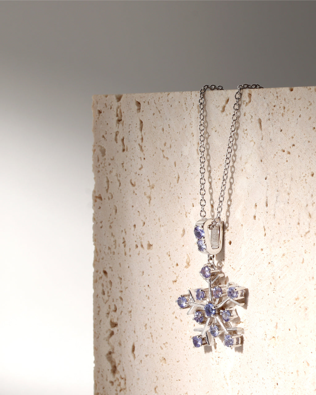 Tanzanite gemstone snowflake pendant in sterling silver — side view
