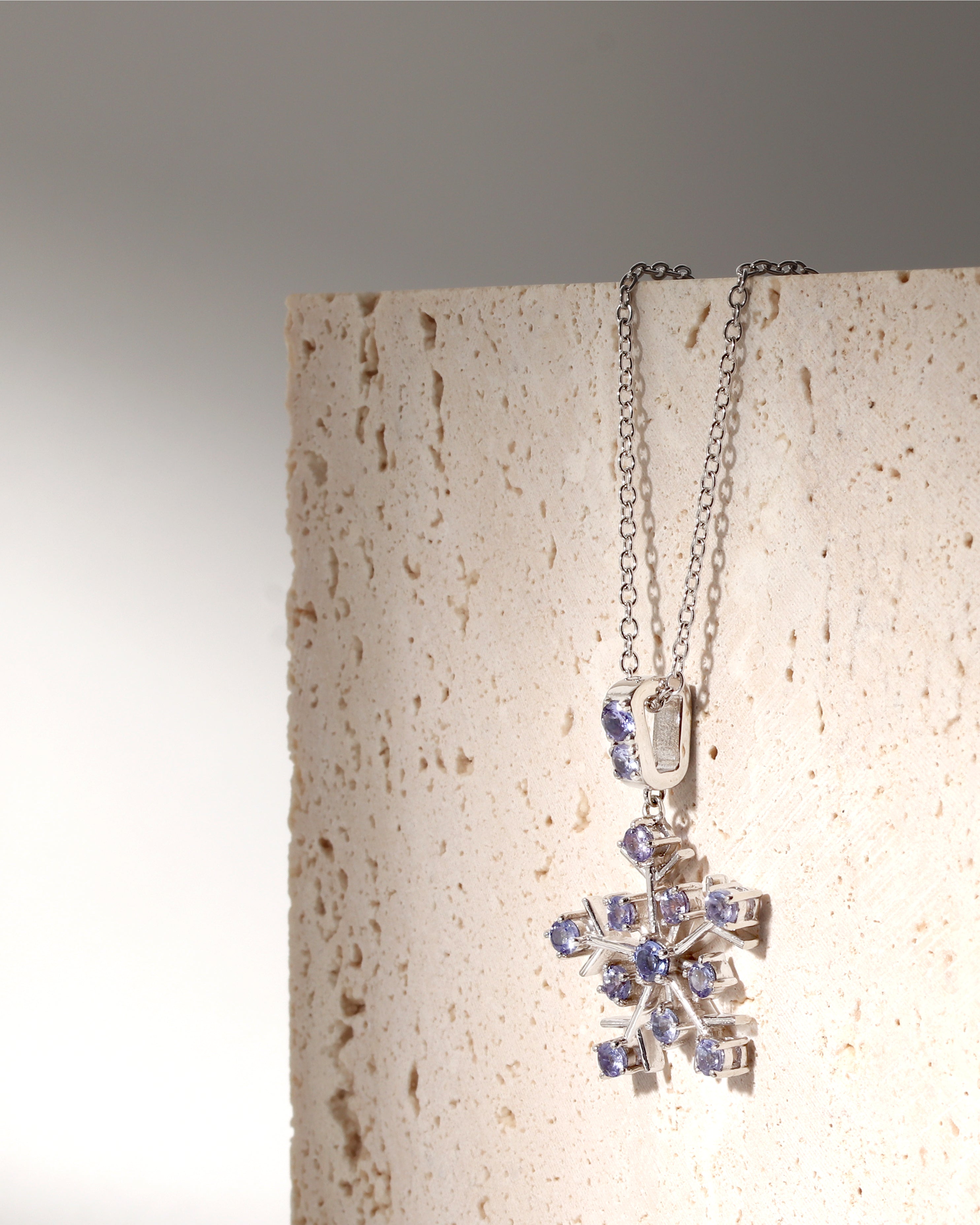 Tanzanite gemstone snowflake pendant in sterling silver — side view