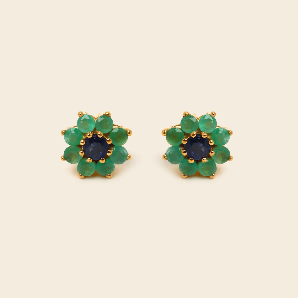 Pair of blue gemstone earrings with silver prongs on a white background