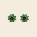 Pair of blue gemstone earrings with silver prongs on a white background