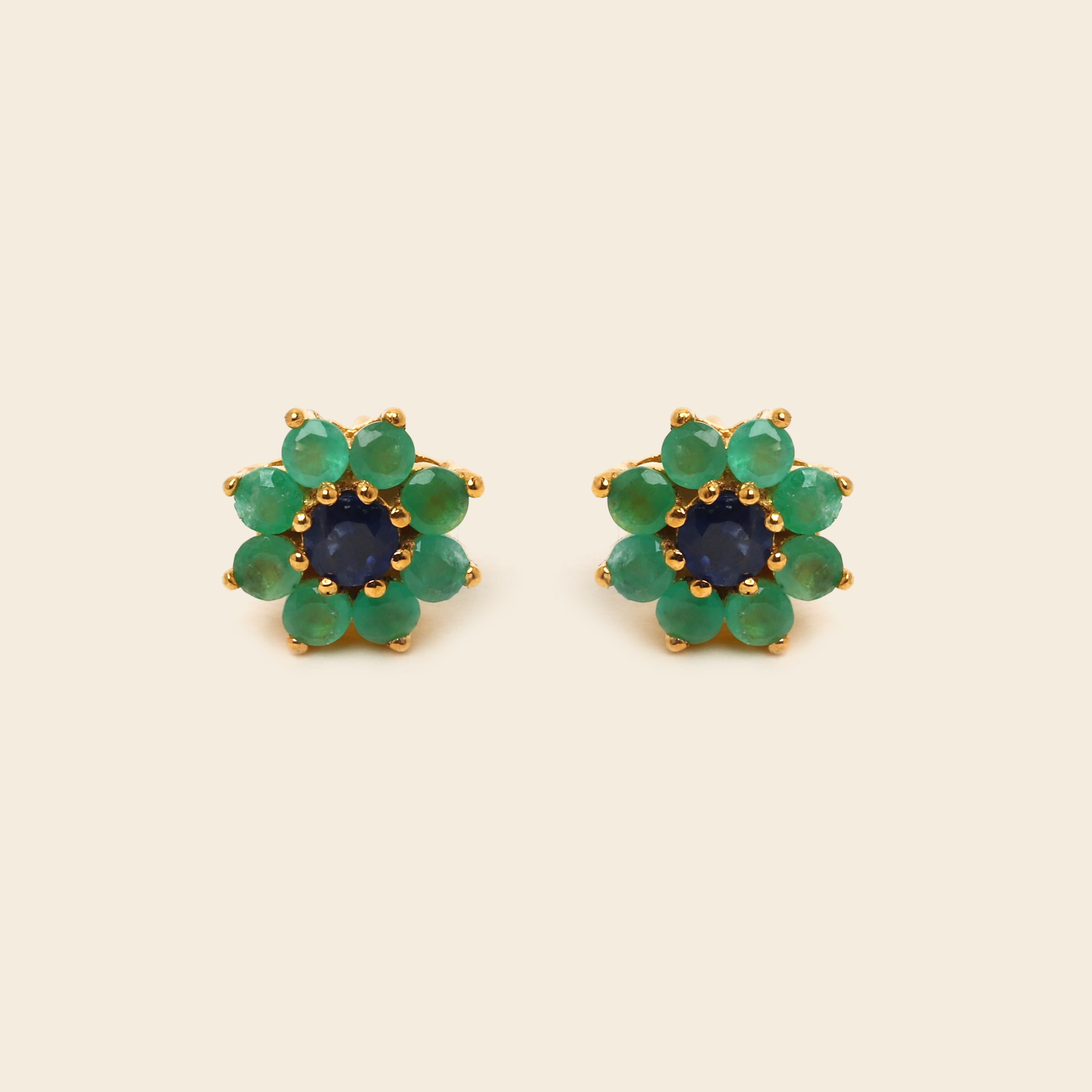 Pair of blue gemstone earrings with silver prongs on a white background