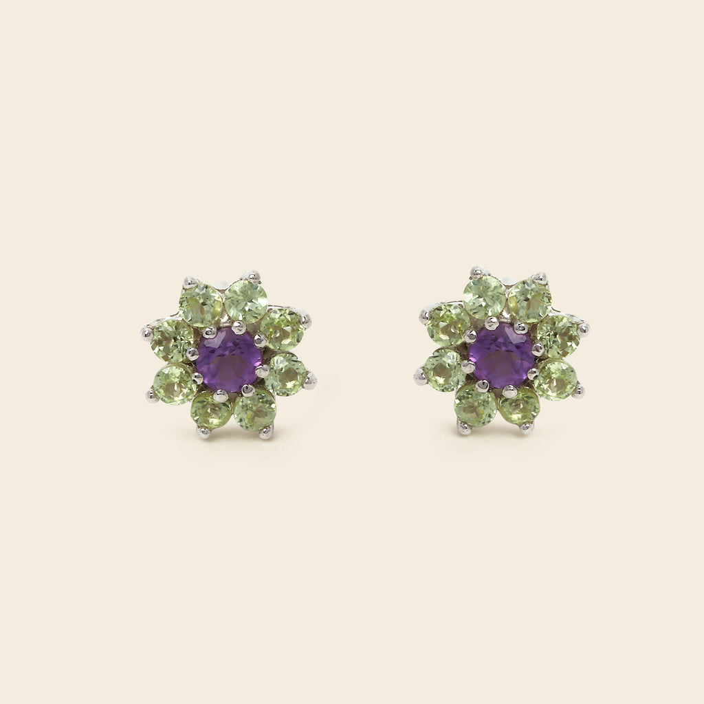 Floral-shaped green gemstone earrings on a white background