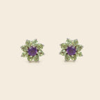 Floral-shaped green gemstone earrings on a white background