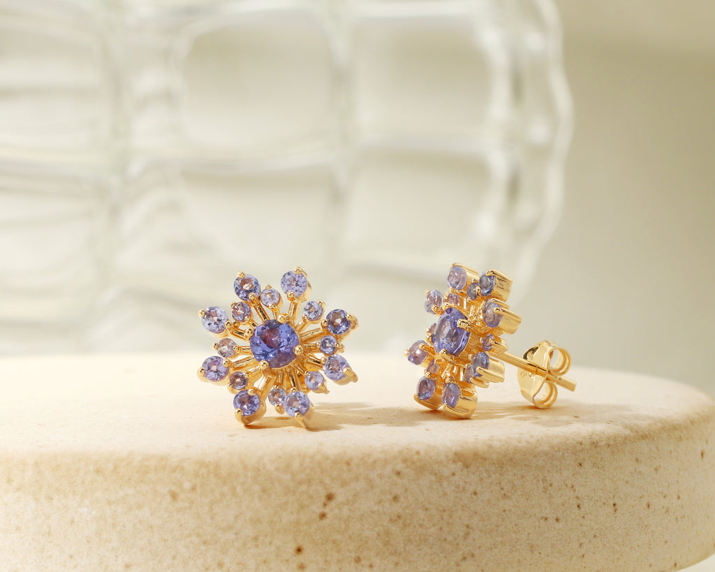 Blue-violet tanzanite snowflake earrings in gold — side view