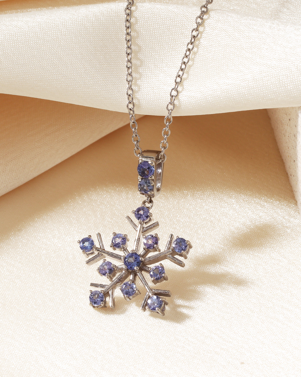 Tanzanite snowflake pendant in polished silver — detail view