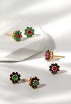 Set of floral earrings with gemstones on a white background