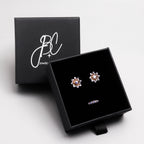 Tanzanite snowflake stud earrings in 18K gold — display view
