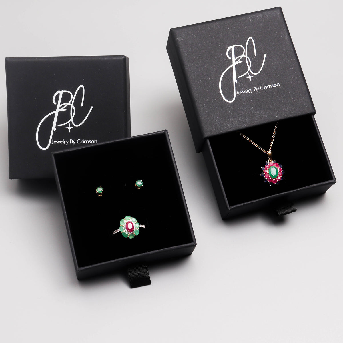 Emerald ruby and sapphire flower pendant in 18K gold — display view