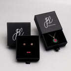 Ruby sapphire and emerald flower pendant in 18K gold — display view