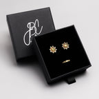 Peridot snowflake stud earrings in 18K gold — display view