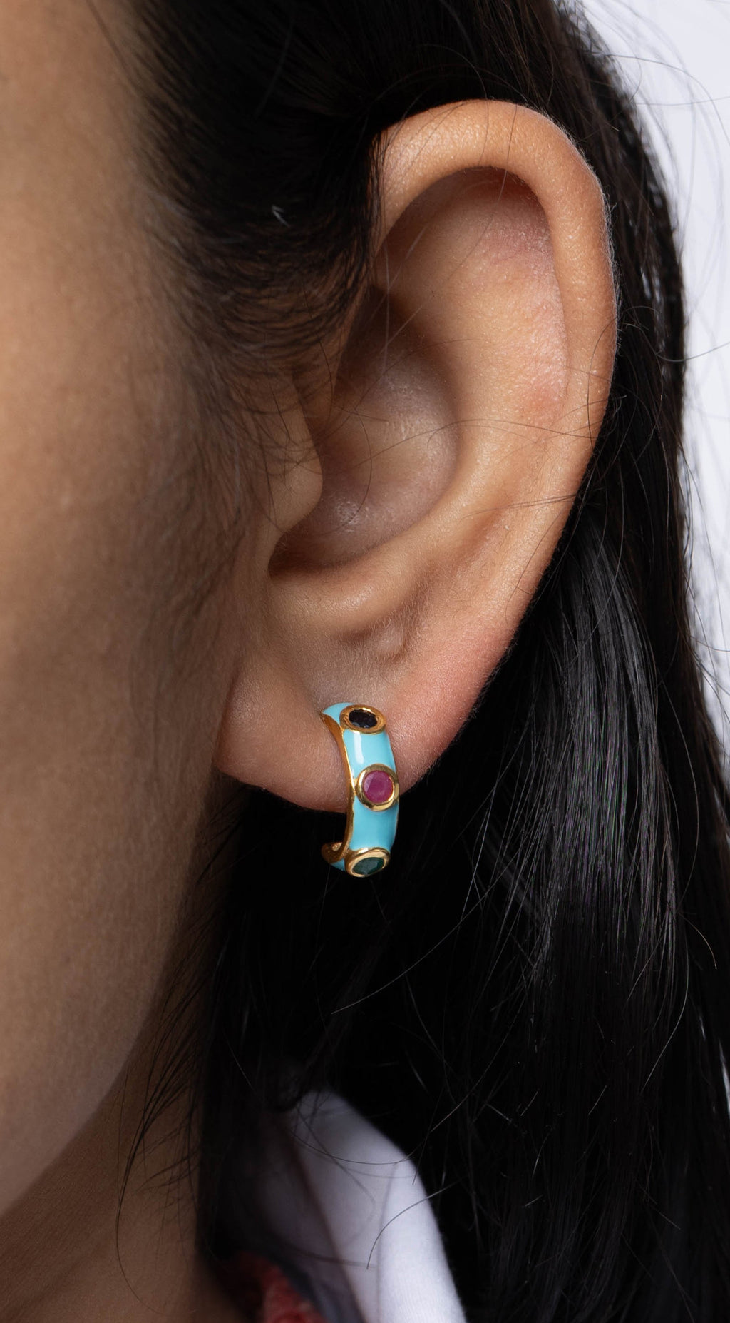 Colorful gemstone huggie earrings with ruby sapphire and emerald accents