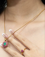 Gold necklace with emerald and ruby pendant, matching ruby ring, elegant gemstone jewelry set