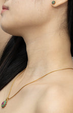 Gold necklace with multicolor gemstone pendant and matching stud earrings, elegant jewelry set