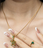 Gold necklace with emerald snowflake pendant and matching emerald ring, elegant gemstone jewelry