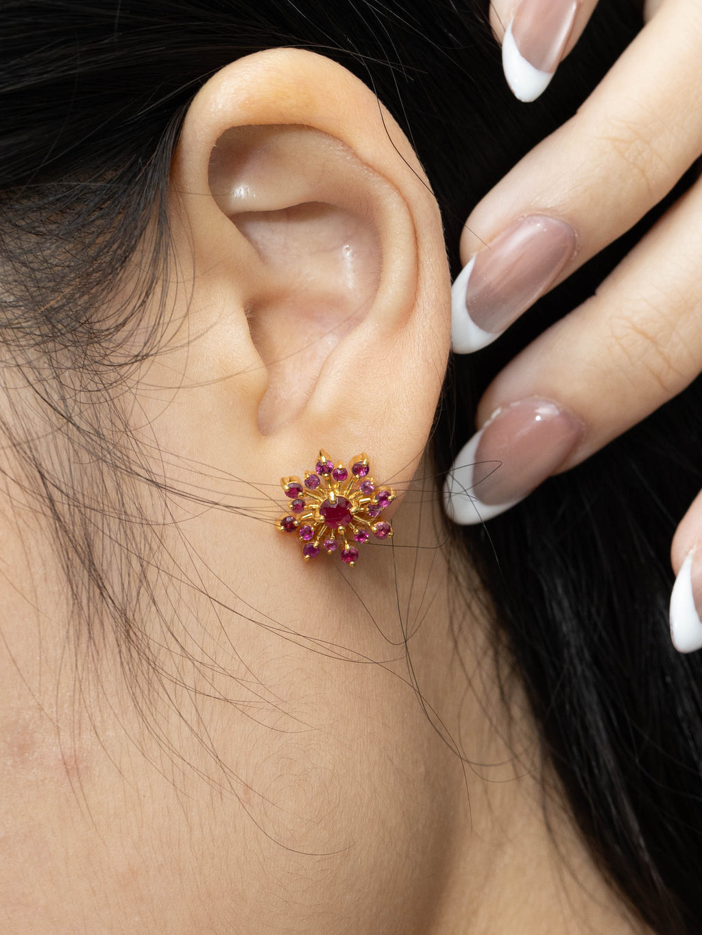 Red gemstone snowflake earrings with polished gold finish