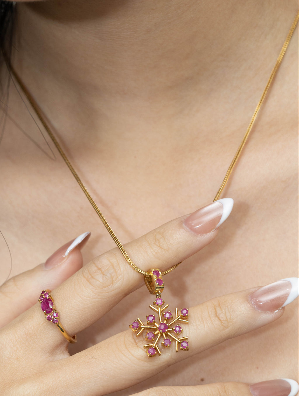 Modern ruby pendant with polished gold finish