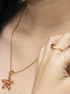 Gold snowflake pendant necklace with ruby gemstones and matching ring, elegant women's jewelry
