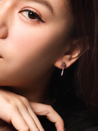 Red gemstone earrings with silver floral design