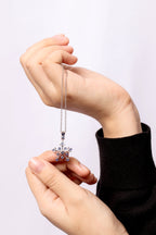 Sapphire snowflake pendant in polished silver — detail view