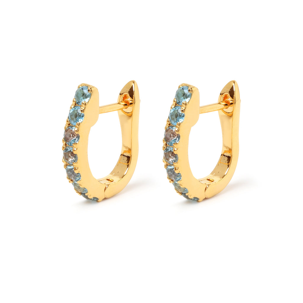 Blue topaz huggie hoop earrings in 18K gold plated sterling silver by Jewelry By Crimson