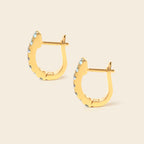 Blue topaz gemstone huggie hoops in 18K gold — detail view