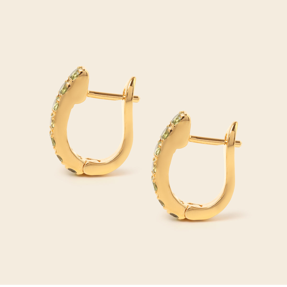 Peridot gemstone huggie hoops in 18K gold — detail view