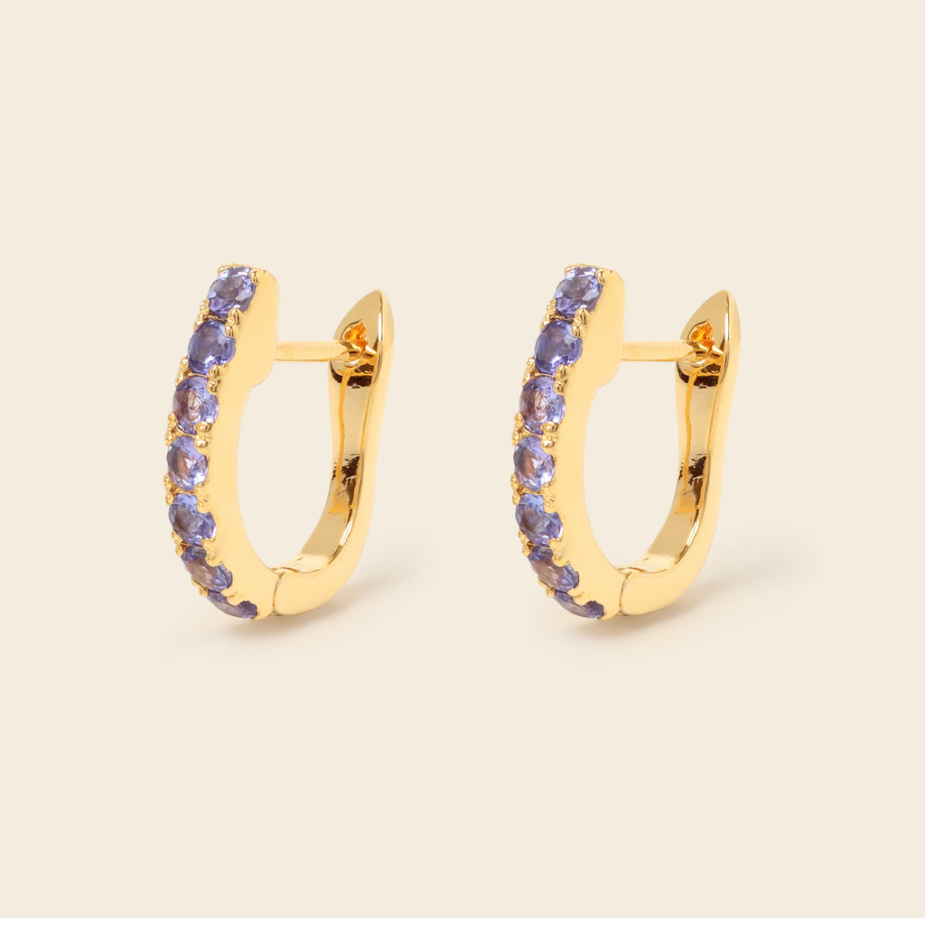 Tanzanite gemstone huggie hoops in 18K gold — detail view