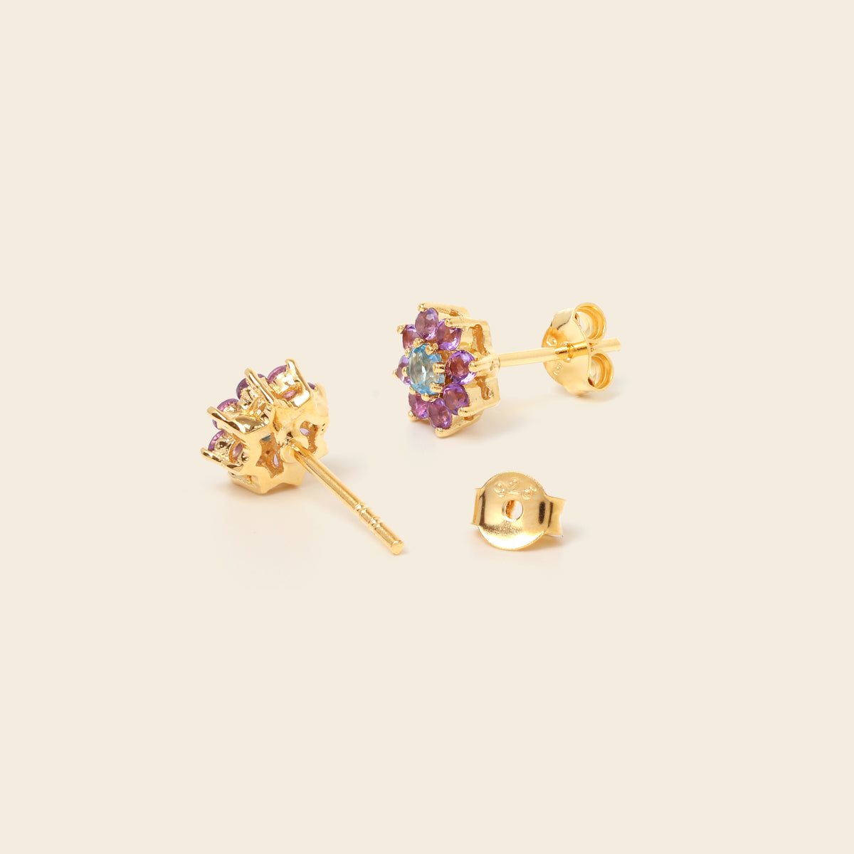 Blue topaz and amethyst floral studs in 18K gold — detail view