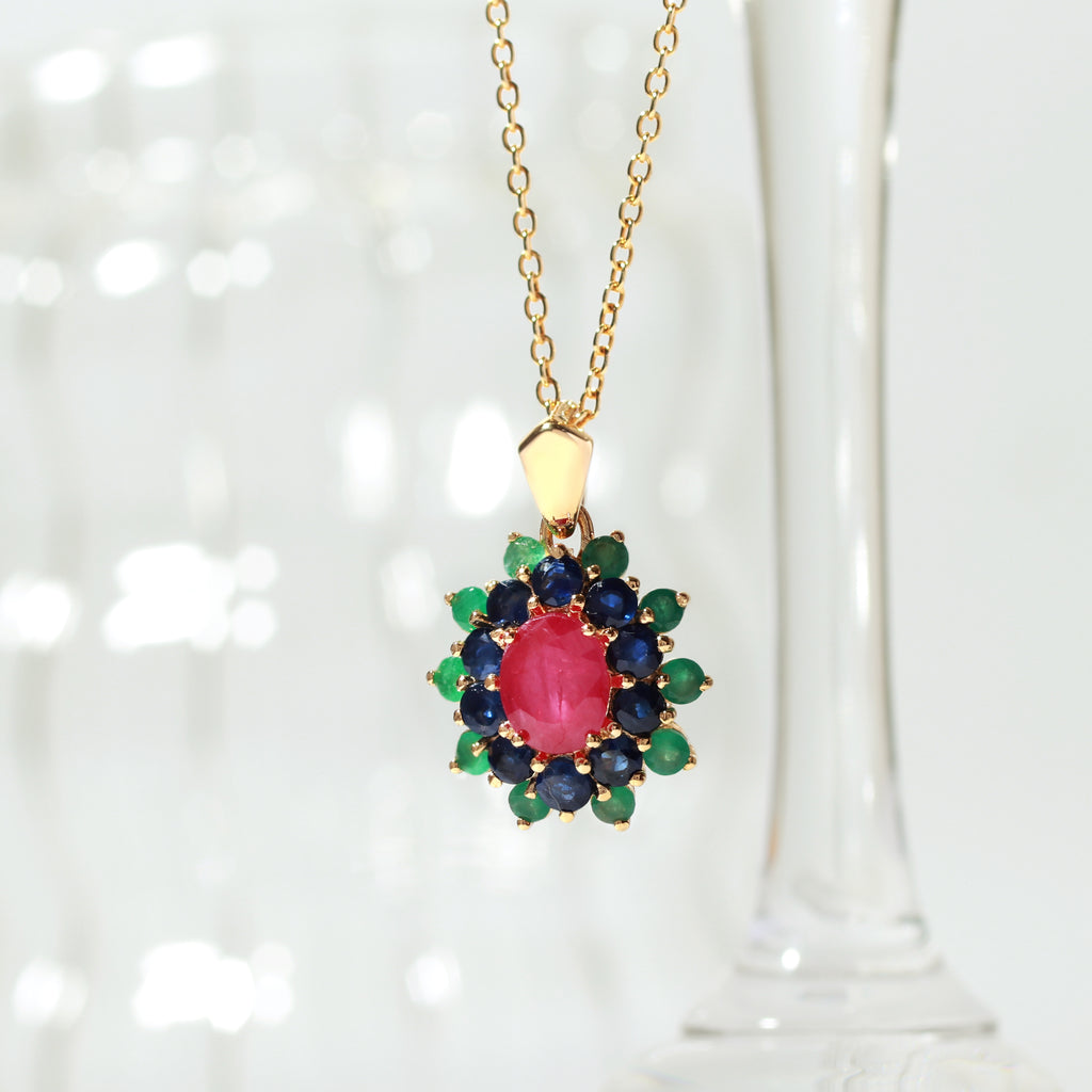 Ruby center with sapphire and emerald petals — flower pendant front view