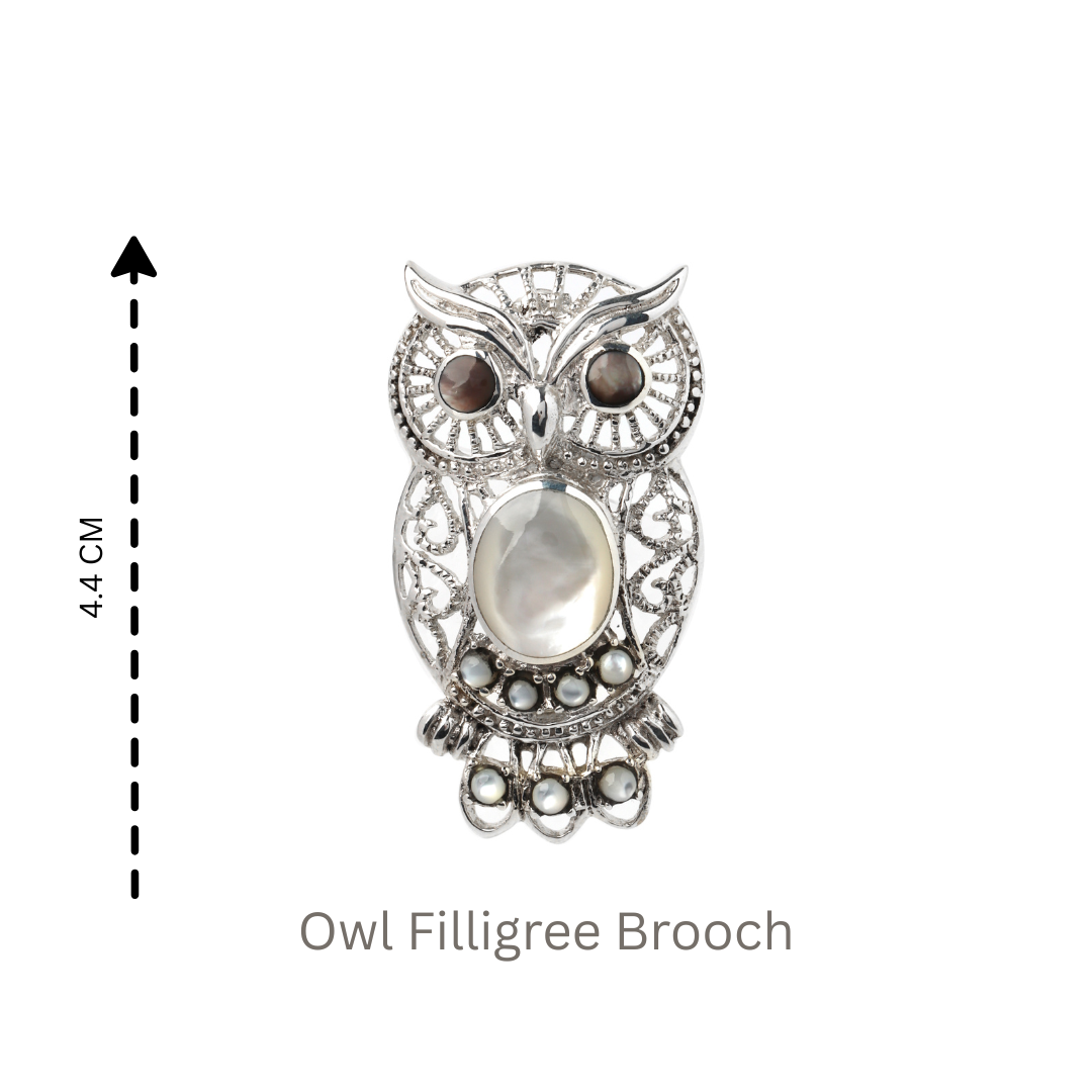 Artisan owl brooch with intricate silver filigree
