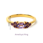 Elegant gold ring with oval amethyst center and purple gemstone accents, 0.5cm width