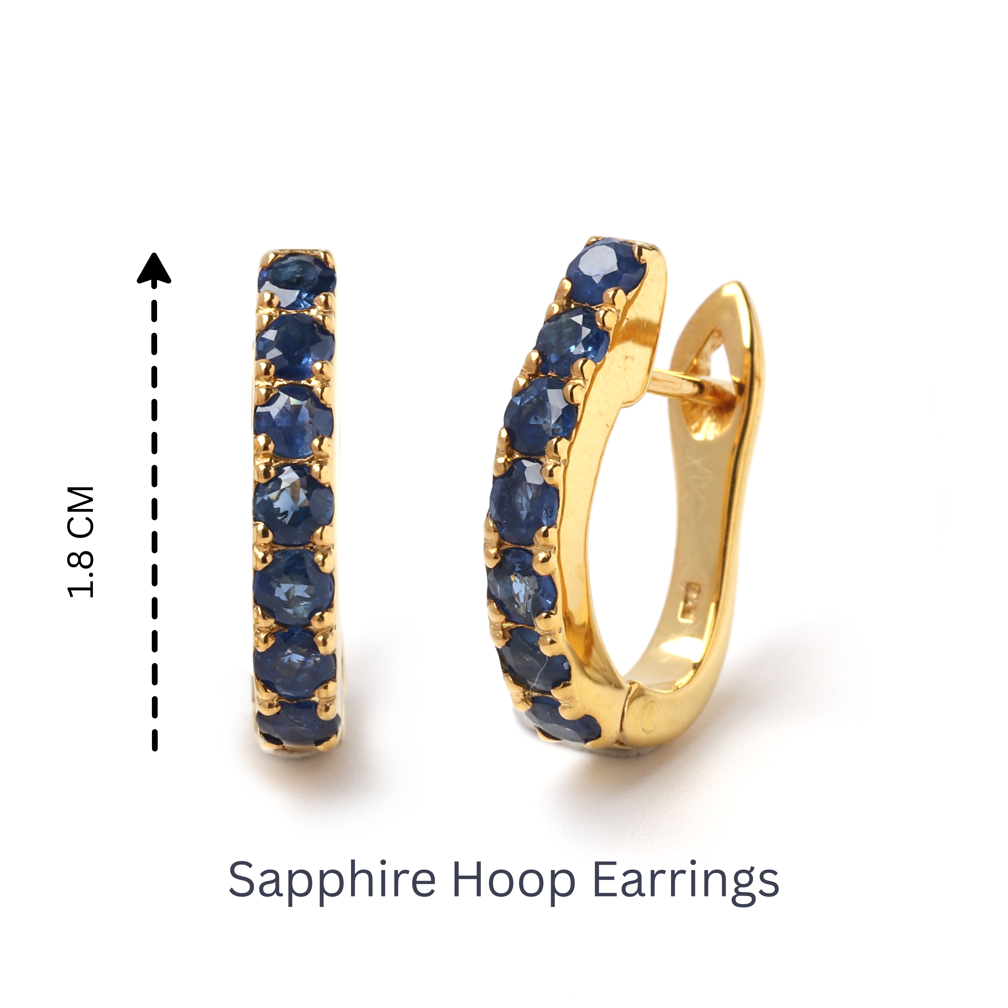 Detail view of prong-set blue sapphire gemstones on gold-finished 925 sterling silver hoop earrings