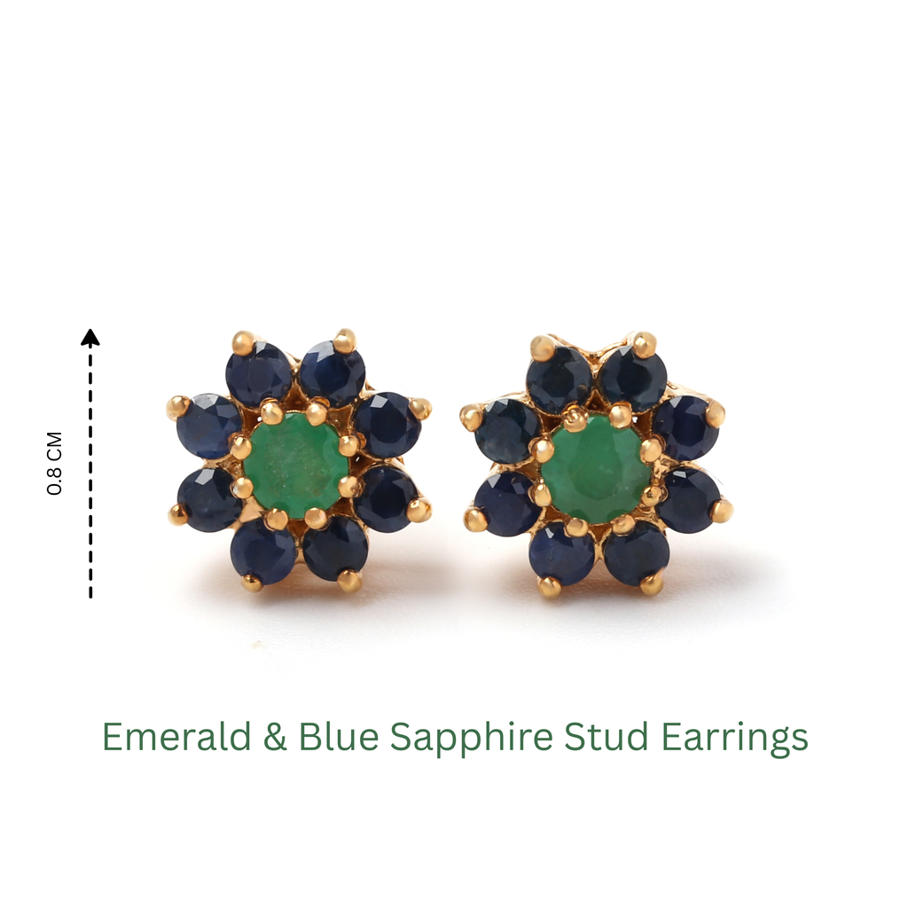Detail of prong-set emerald center with blue sapphire cluster in gold-finished 925 sterling silver