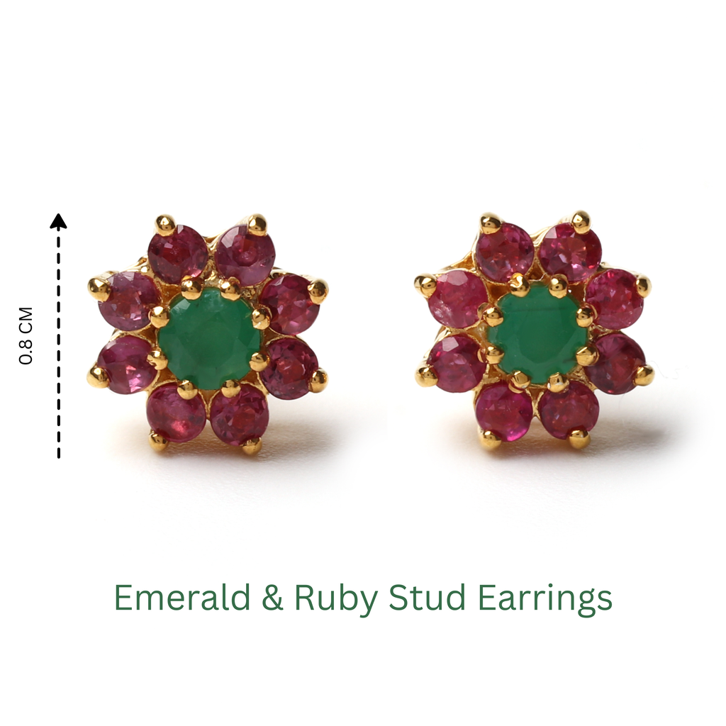 Detail view of prong-set emerald center with ruby accents in gold-finished 925 sterling silver earrings