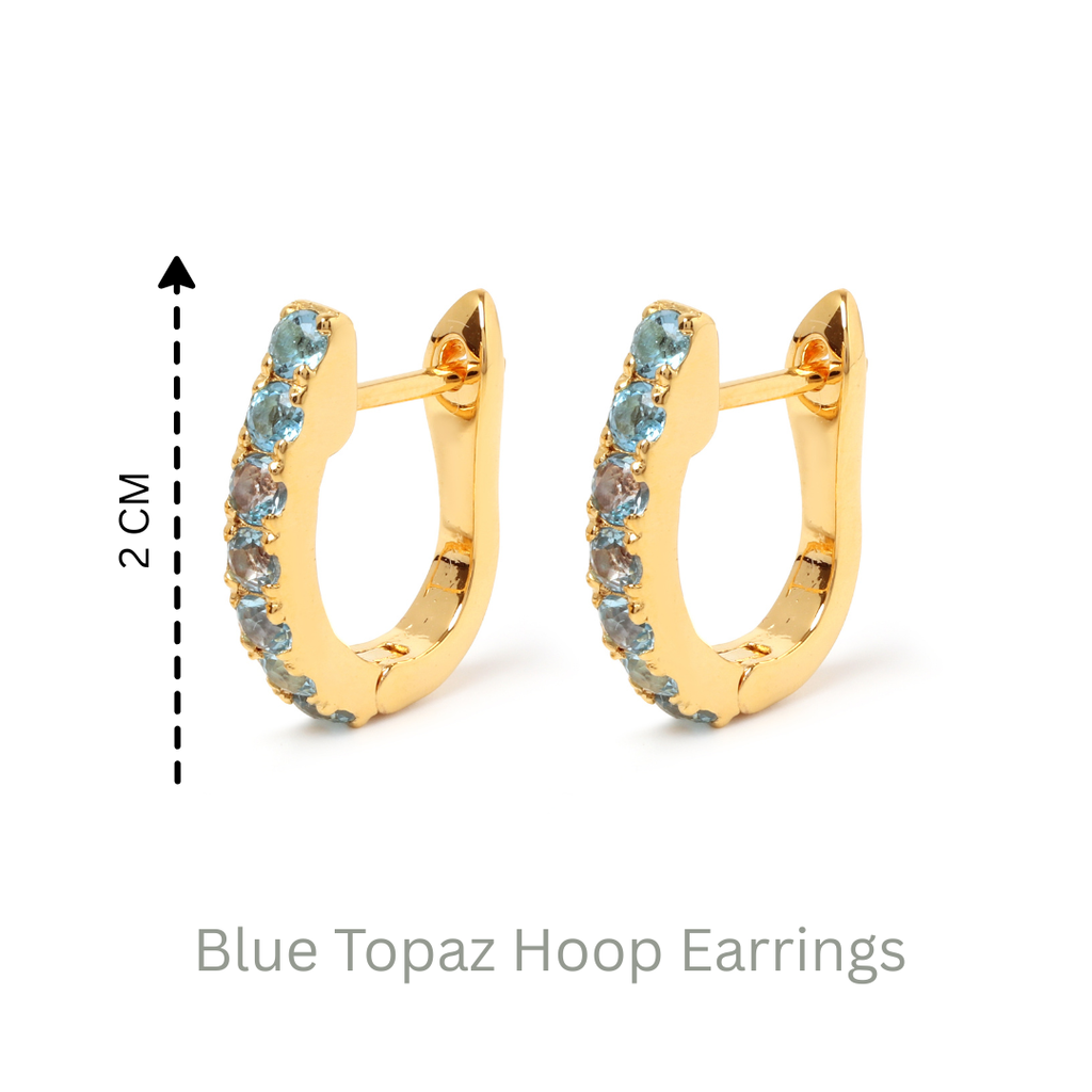 Blue topaz huggie hoop earrings in 18K gold — display view