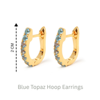 Blue topaz huggie hoop earrings in 18K gold — display view