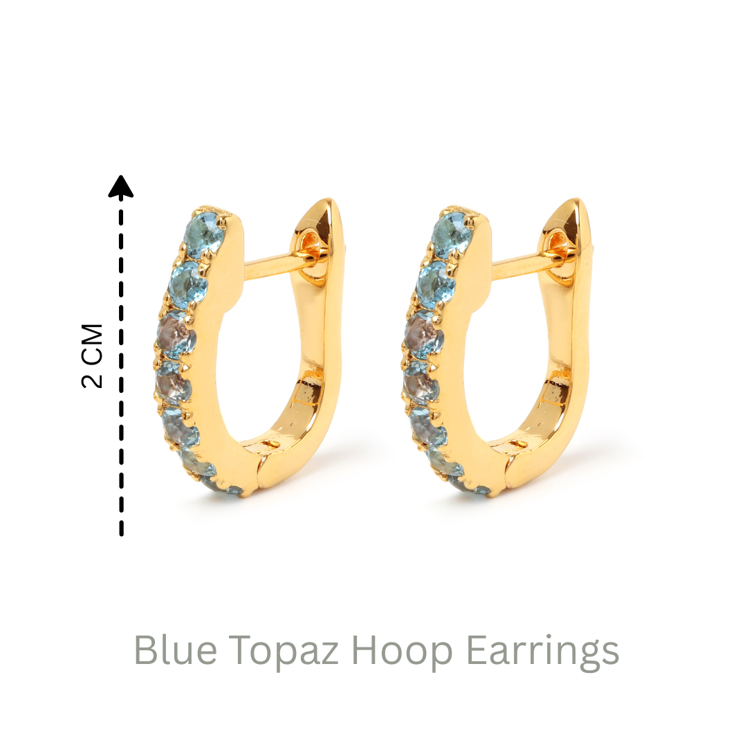 Blue topaz huggie hoop earrings in 18K gold — display view