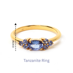 Elegant gold ring with oval tanzanite center and accent stones, 0.5cm height