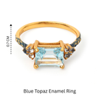 Gold ring with blue topaz gemstone and enamel accents, 0.7 cm height