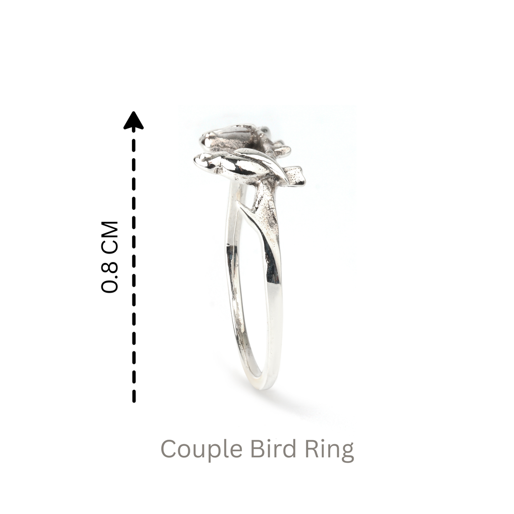 Detail view of sculpted twin birds on 925 sterling silver ring with smooth slim band