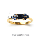 Elegant blue sapphire ring with gold band, featuring a central oval gemstone and smaller accents.