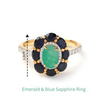 Emerald and blue sapphire flower ring with diamond accents, 1.3cm wide, gold band