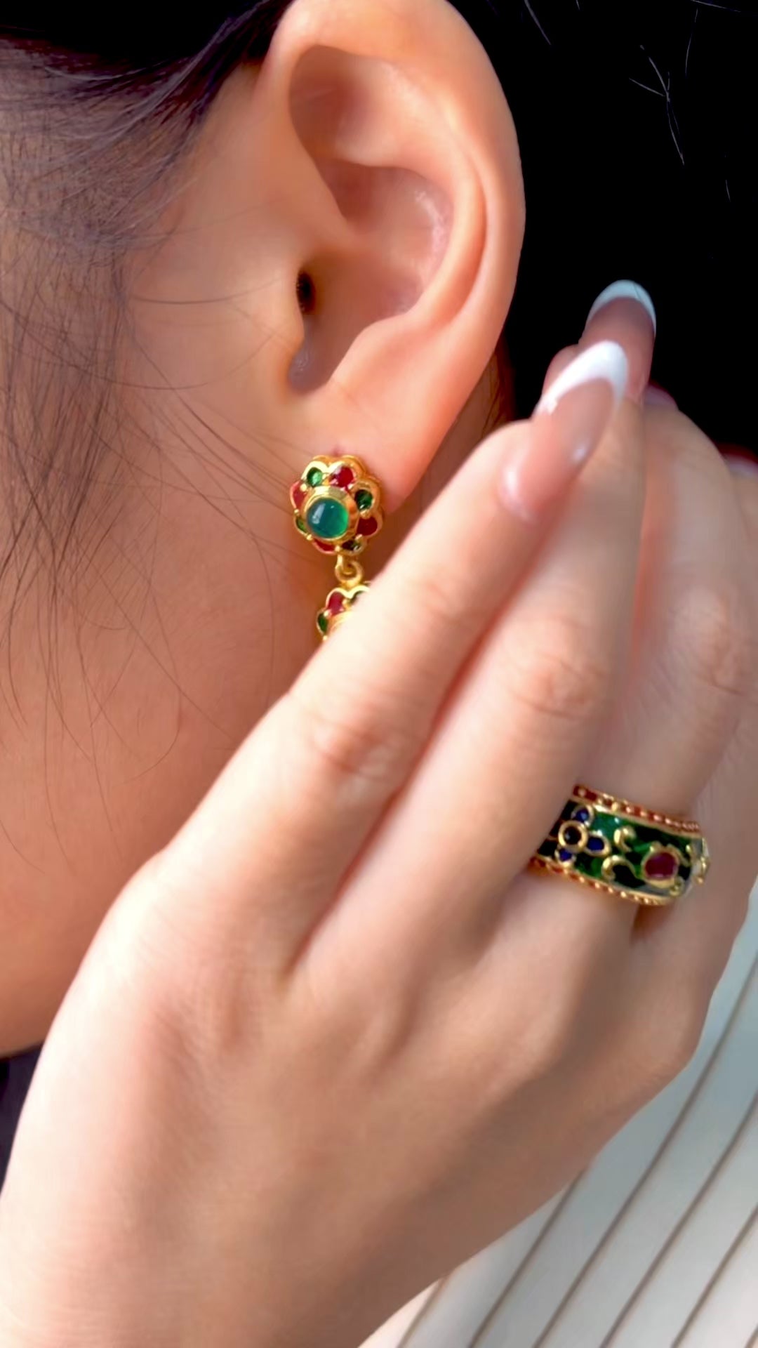 Artisan emerald drop earrings featuring intricate floral detailing